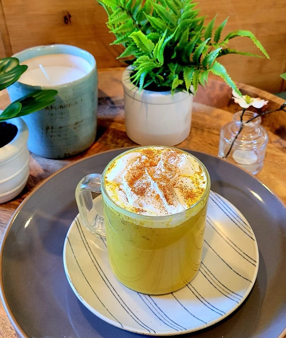 Golden milk latte with turmeric and cinnamon in a cozy home setting
