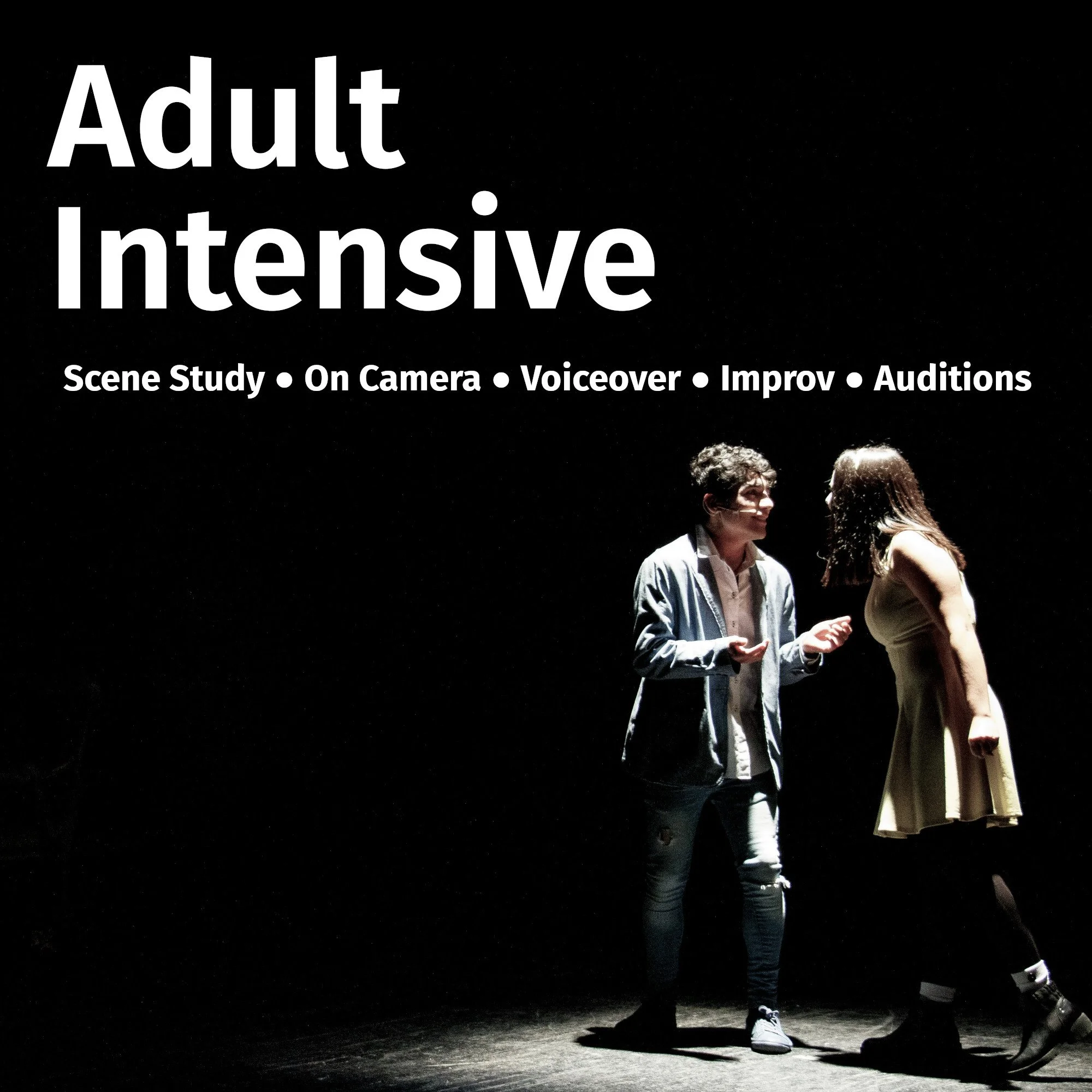 A scene from a theatrical performance with two actors on stage, one male and one female, under a spotlight against a dark background.