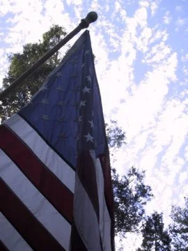 American flag against a cloudy sky