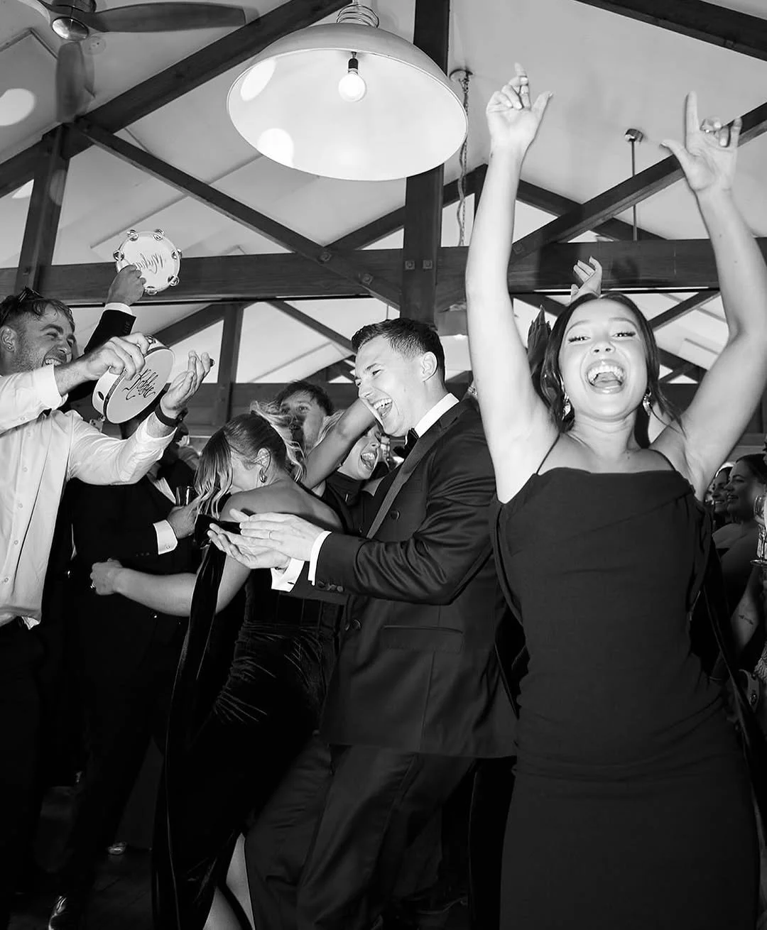 People dancing and celebrating at a party, smiling and having fun.