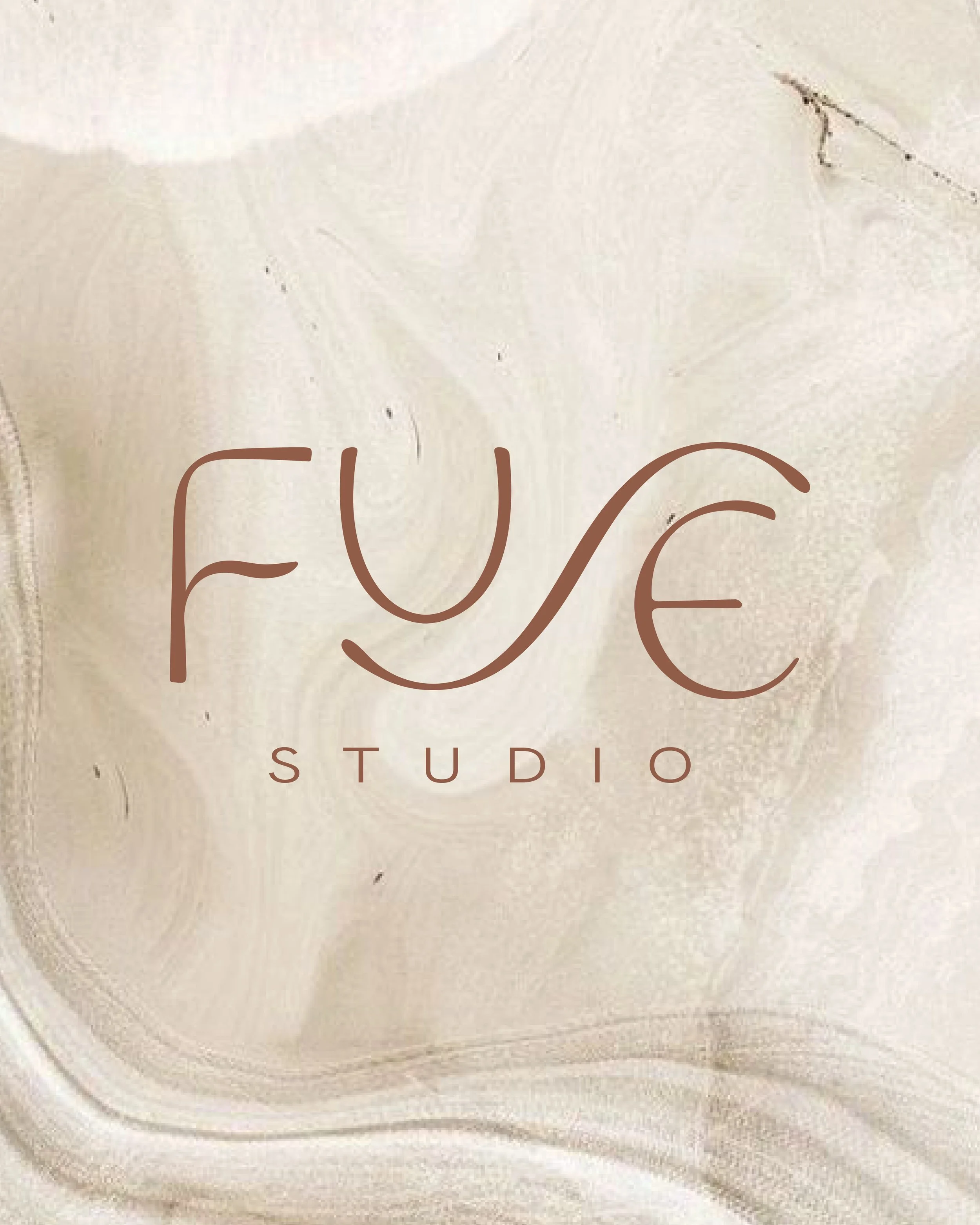Logo for local North Carolina Hair Salon: Fuse Studio on a beige marble background.