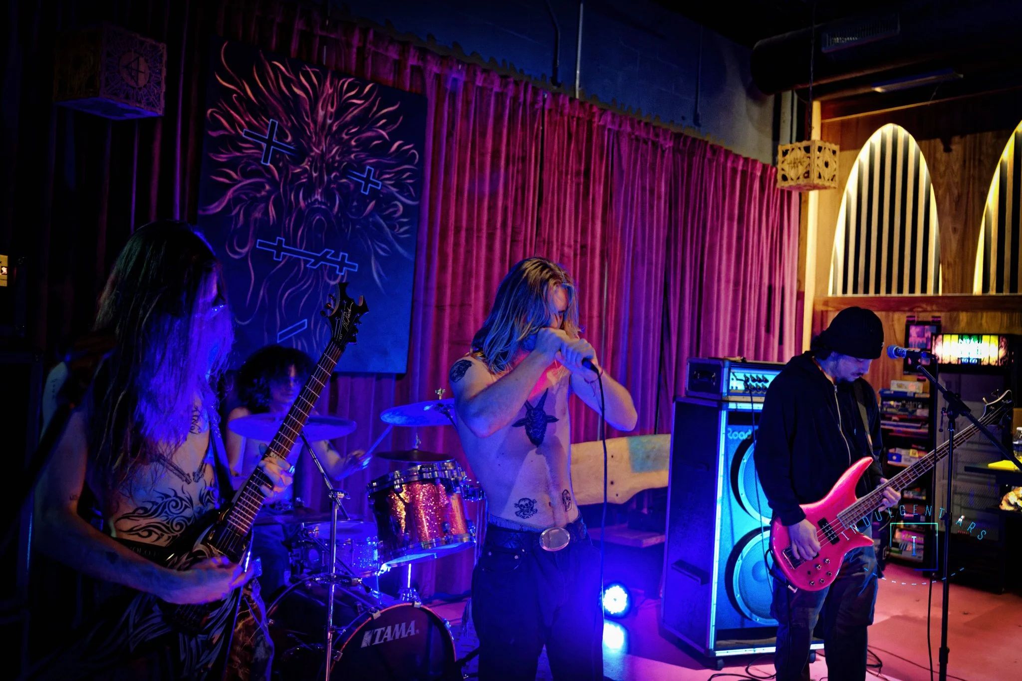 Slowrot captured in action. From left to right we have the guitarist, drummer, lead vocals, and bassist. The lighting here, better illuminates the drummer in the background. 