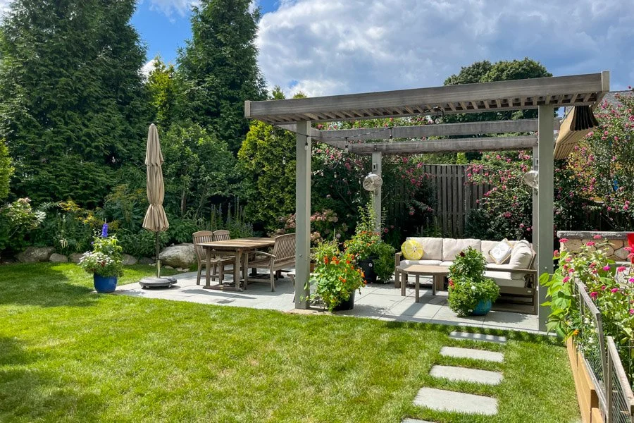  Large wood and metal pergola with fans and fabric shade on large bluestone patio 