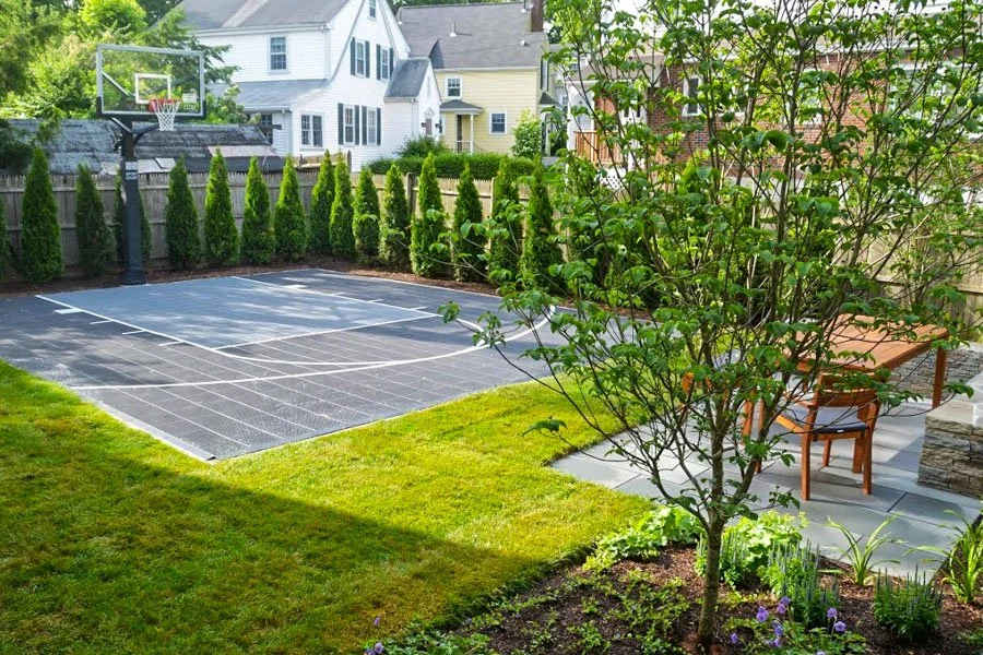  Sports court and basketball hoop enclosed with screen hedge with viewing patio 