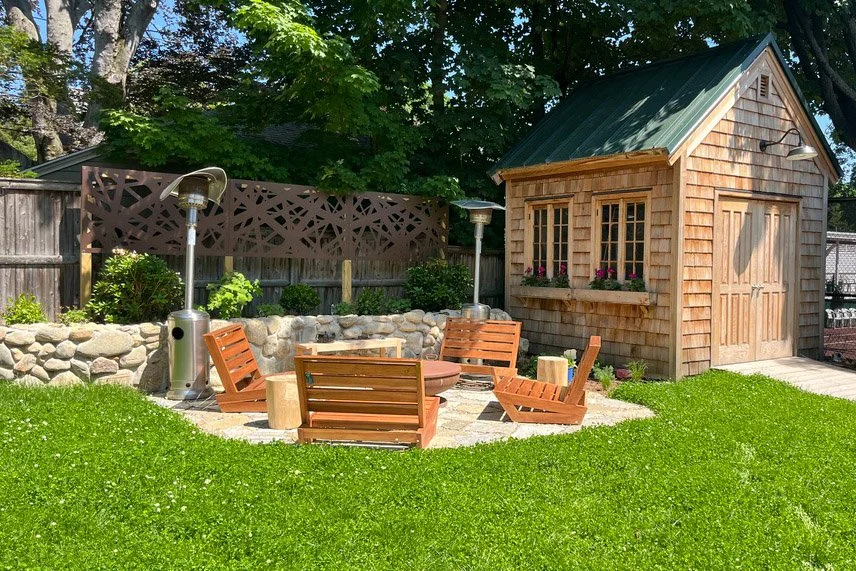  Microclover lawn with field stone retaining wall, stone patio with shingled shed 