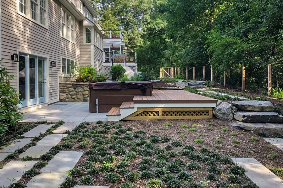 Site Master Planning | Image of a backyard with a hot tub, wood deck, bluestone patio and stone steps