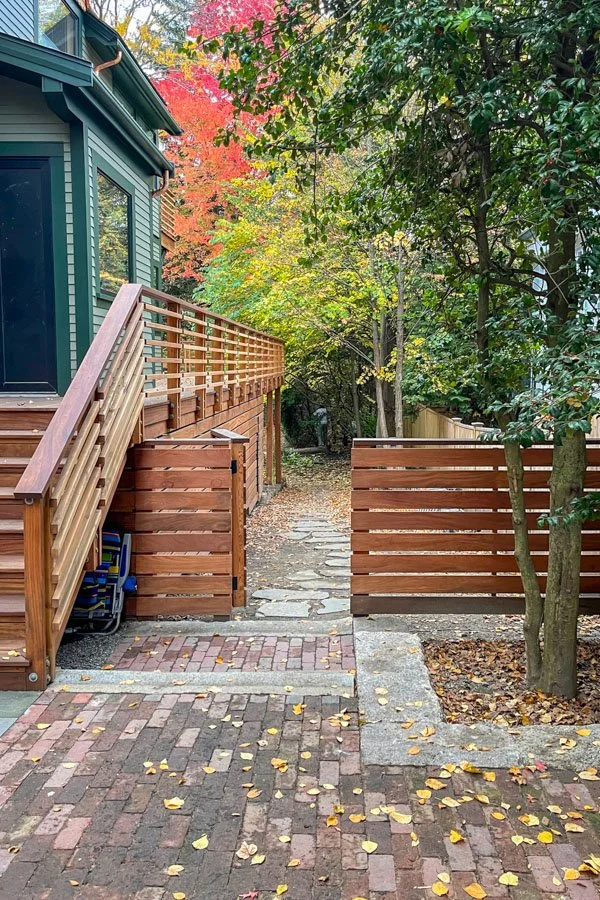 Brick paved parking court with monolithic granite steps and edging