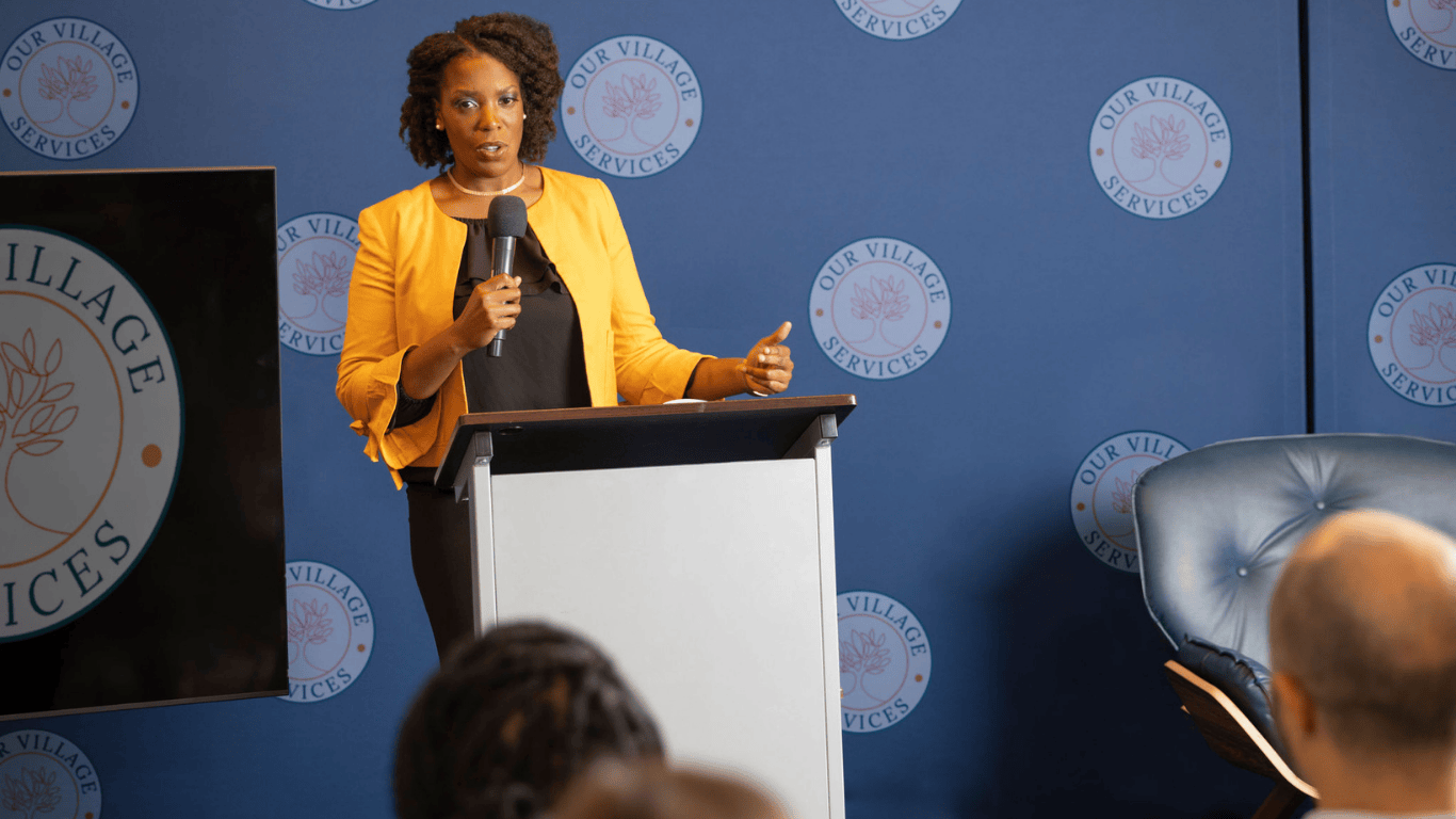 Dr. Tanya Henderson speaking at an Our Village Services (OVS) event—workshops and talks available in the Capital District and nationwide.