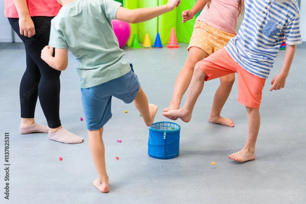 Children playing a game in a playroom with colorful cones and balls.