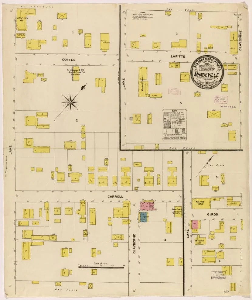 Map of Mandeville, Louisiana, showing property plots, streets, and buildings from 1909, with a focus on Lake Drive, Carroll, LaFitte, Clayborne, and other areas, marked with annotations and a compass.