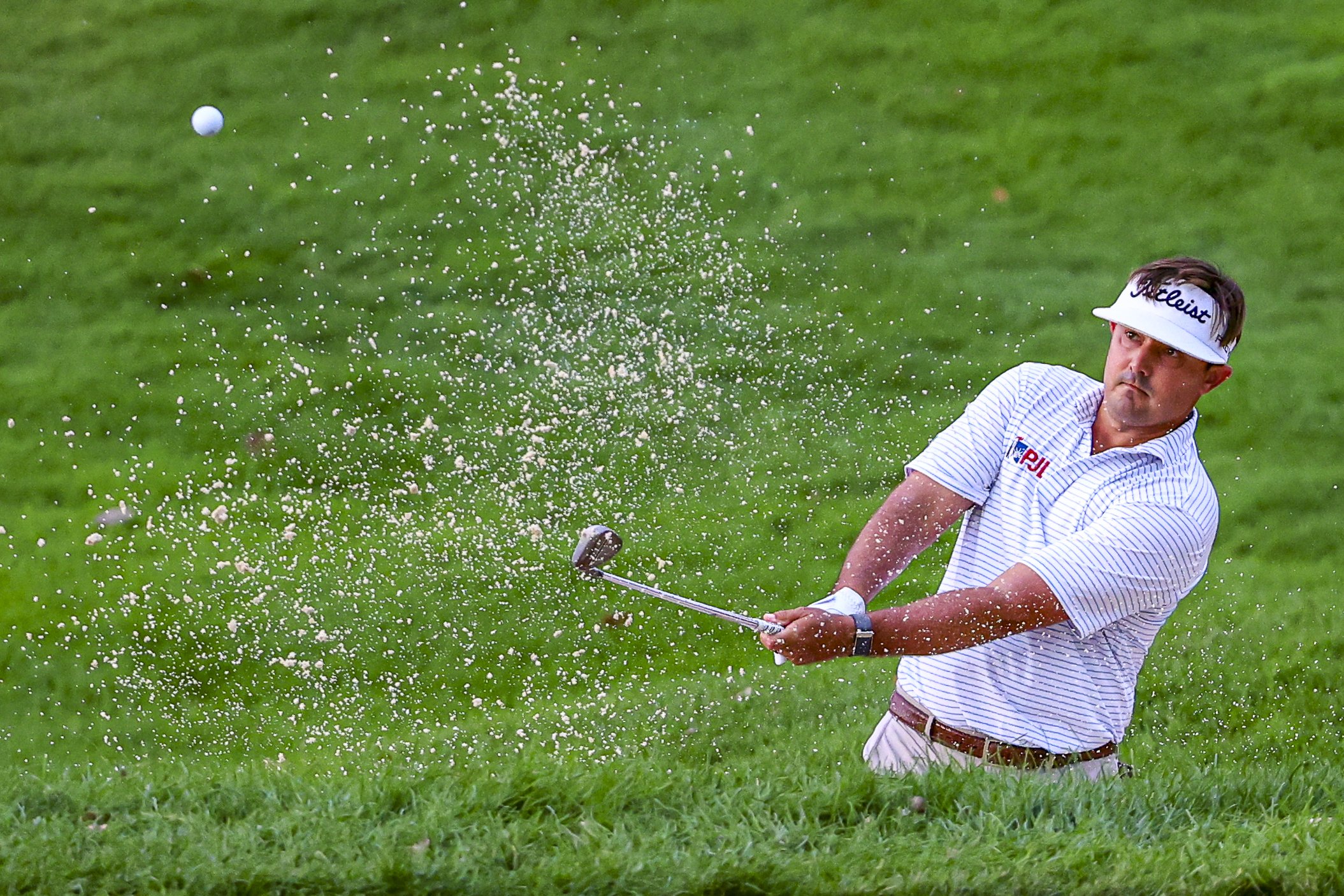 PGA golfer Hank Lebioda hits a chip shot out of the bunker at TPC Twin Cities during the 2026 3M open in Blaine, Minnesota.