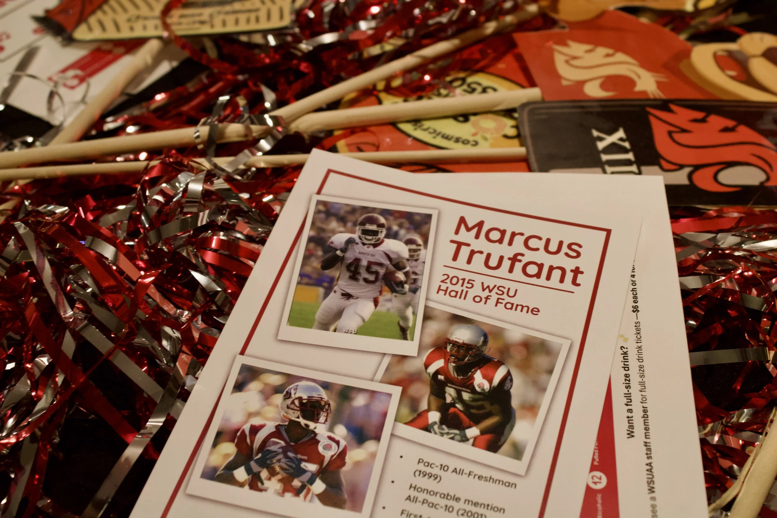 Flyer for Marcus Trufant's 2015 WSU Hall of Fame. The flyer features three football photos of Marcus Trufant in his college football uniform and information about his awards and career.