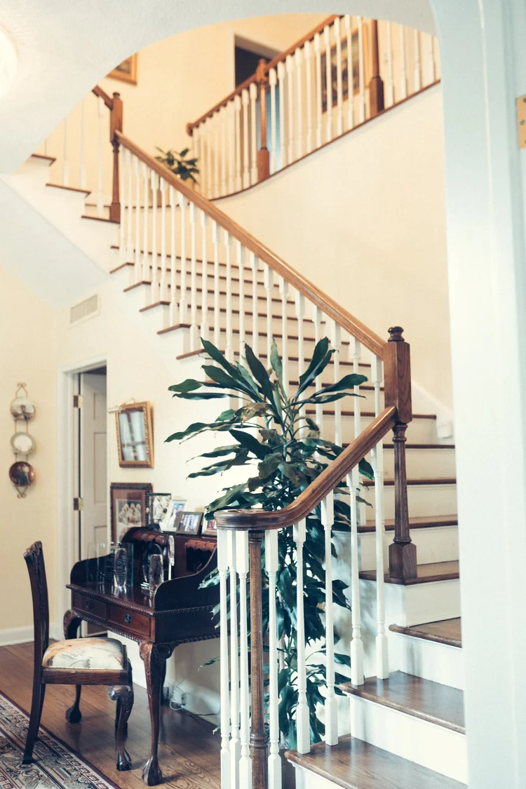 The restored staircase and original red oak flooring inside Mann Manor in Bartow, Florida