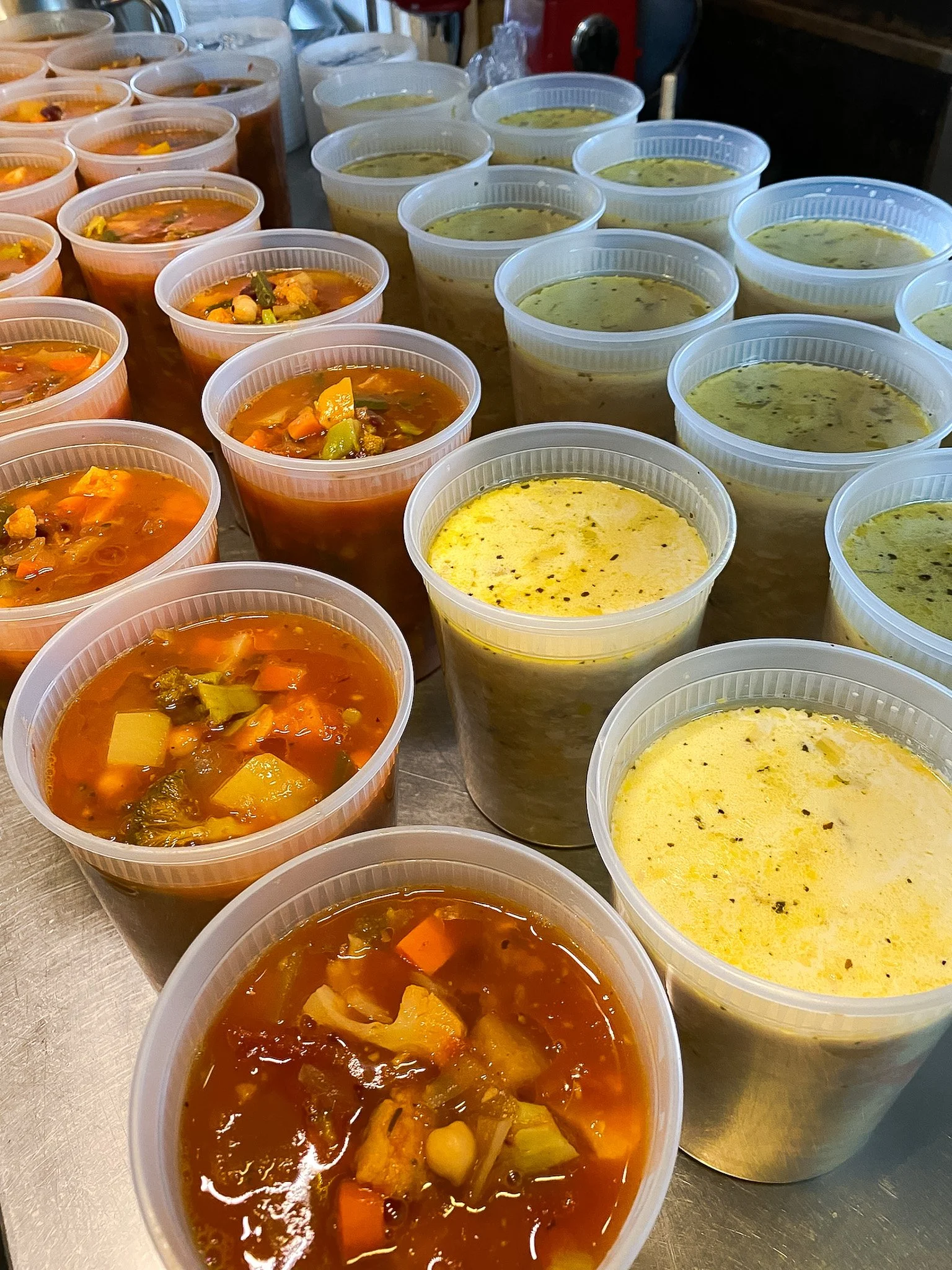 Multiple containers of soup for Leaf Kitchen's take-home meal service