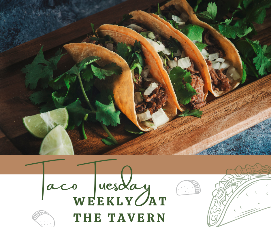 Three beef tacos with chopped onions and cilantro on a wooden platter, garnished with lime wedges and fresh cilantro.