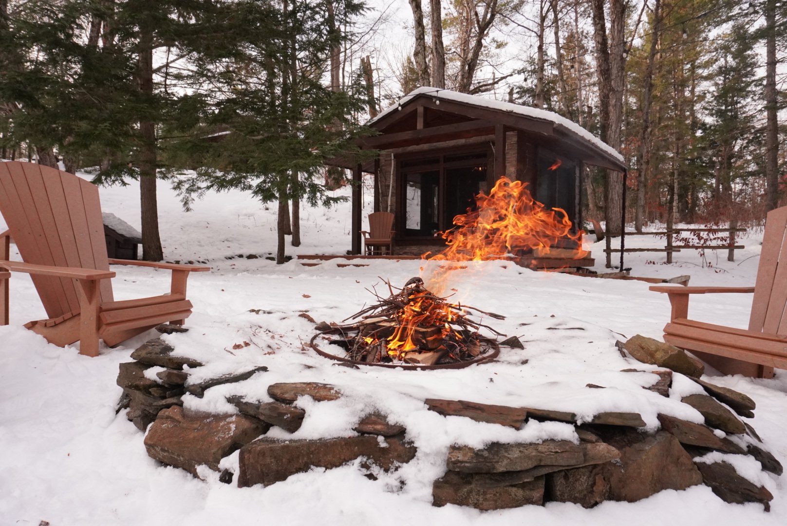 Riverfront fire pit at the Black River Retreat private couples resort