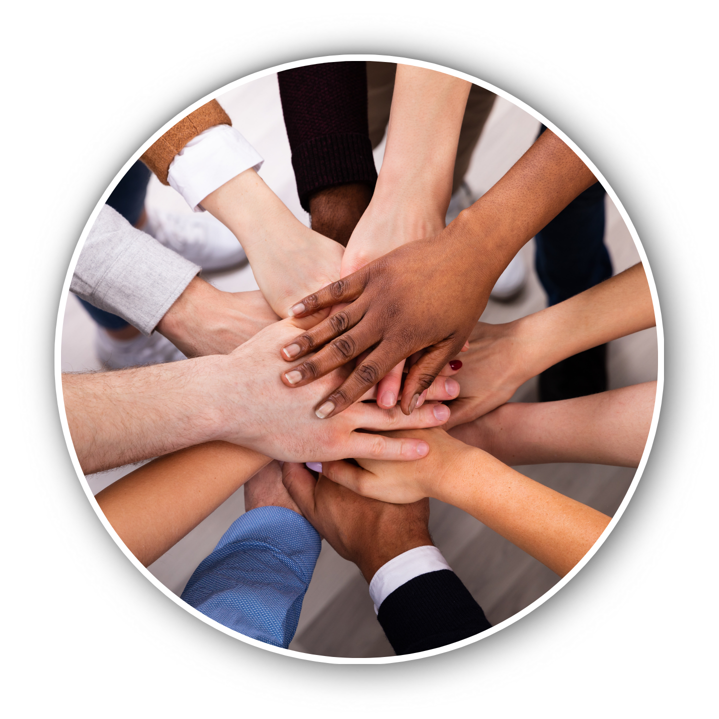 Multiple hands of different skin tones stacked together in a show of unity and teamwork.