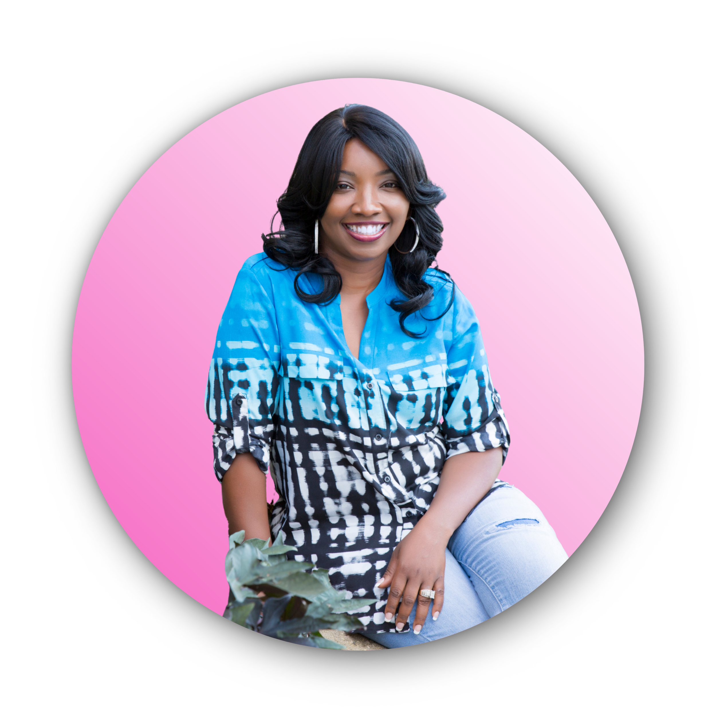 A smiling woman with shoulder-length black hair in loose waves, wearing hoop earrings, a blue patterned shirt, and ripped jeans, sitting outdoors against a pink gradient background.