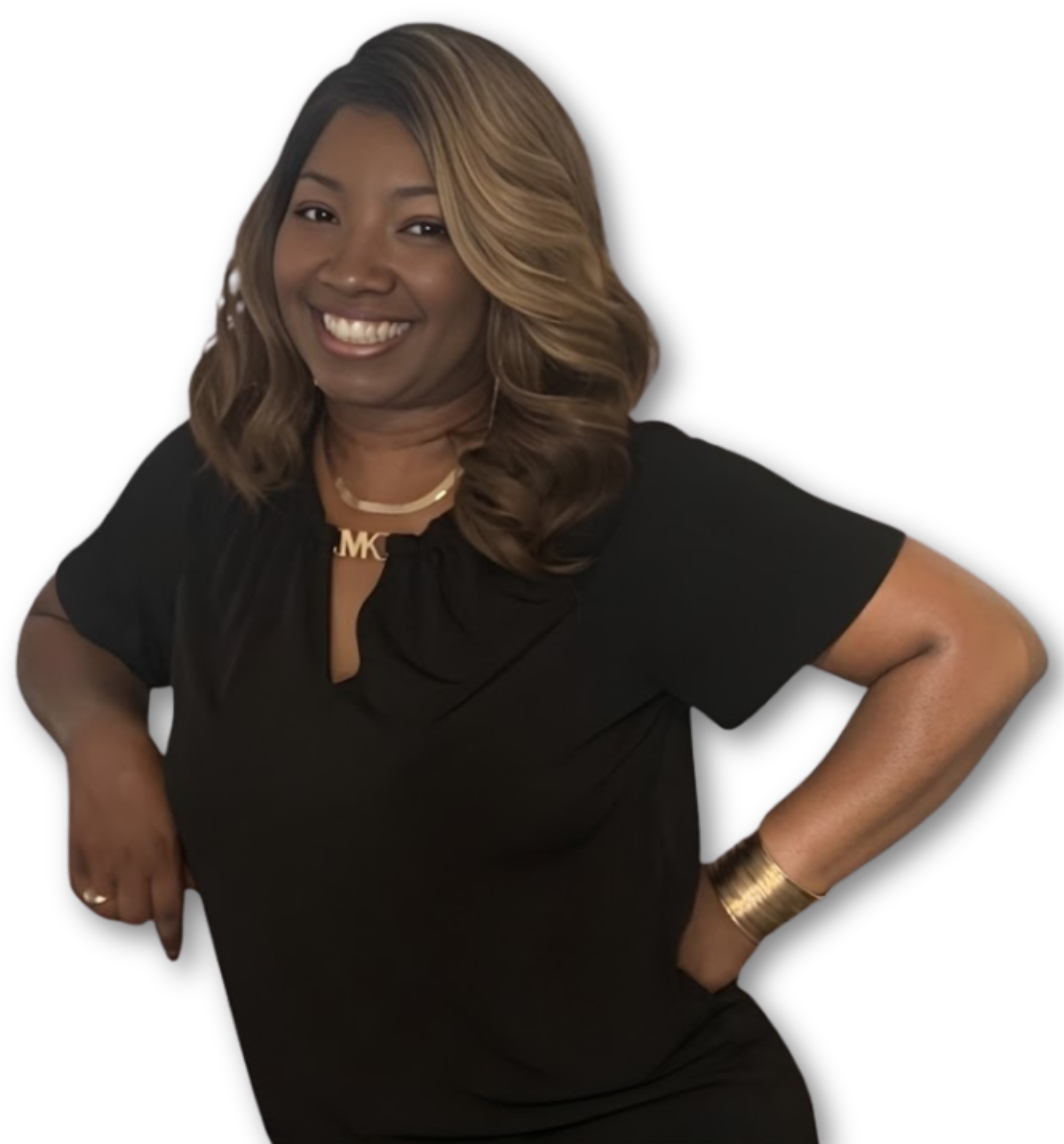 A woman with shoulder-length wavy hair, wearing a black dress, gold necklace, bracelet, and ring, smiling with hands on hips.