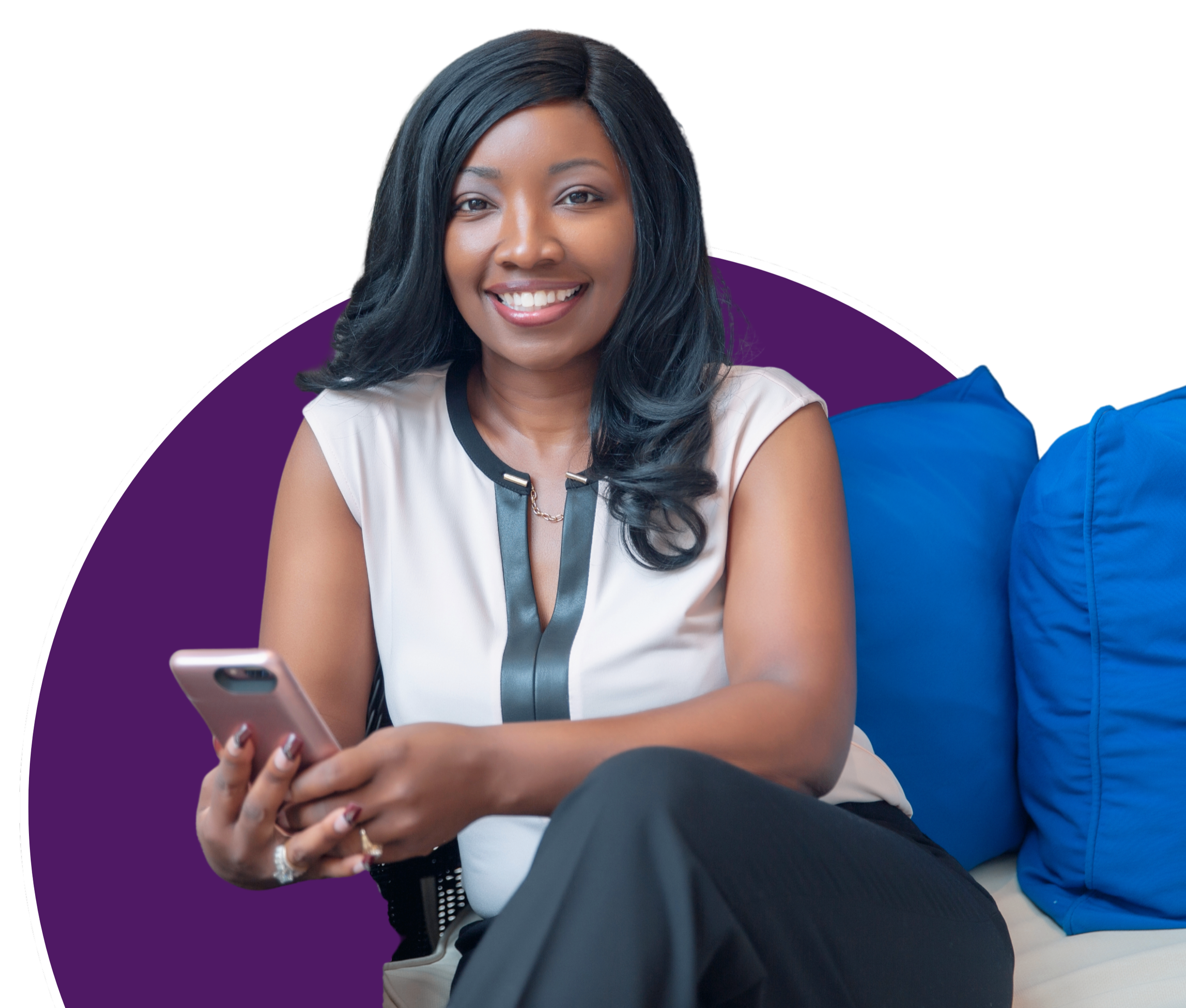 Smiling woman with dark hair sitting on a blue couch, holding a smartphone, wearing a sleeveless blouse with black accents.