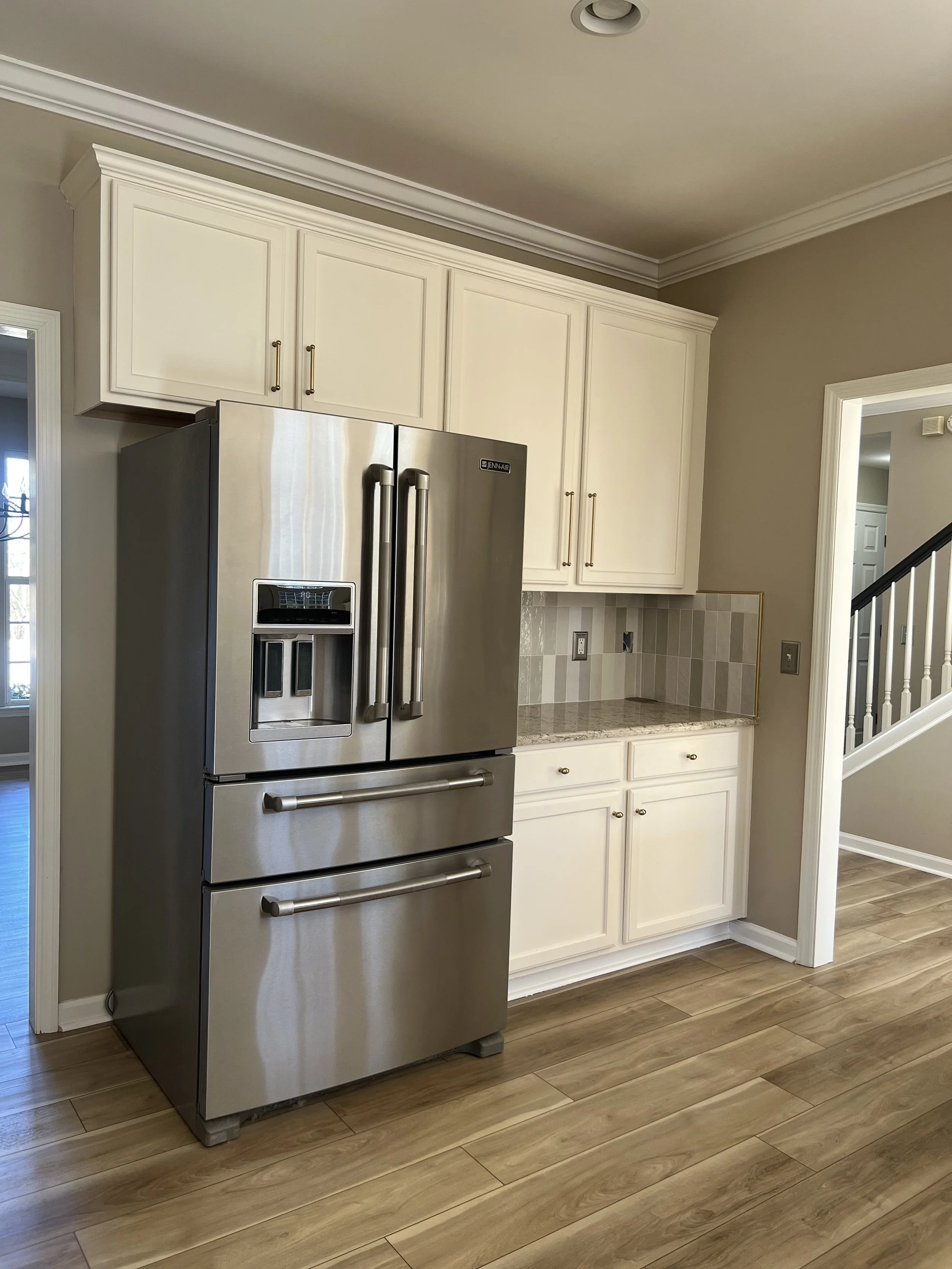 Stainless steel refrigerator exterior cleaned and polished in kitchen.
