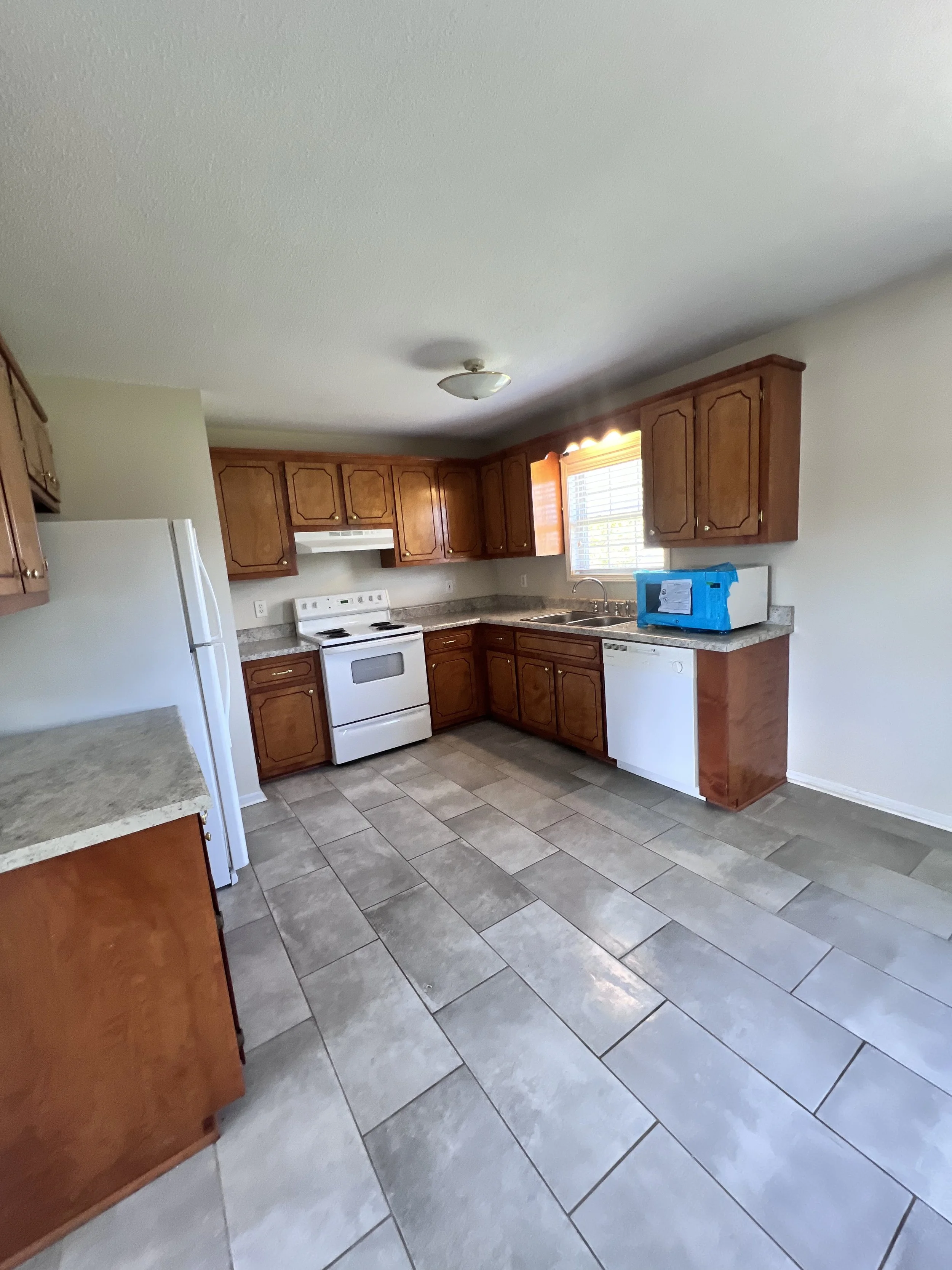 Kitchen fully cleaned including appliances and countertops.