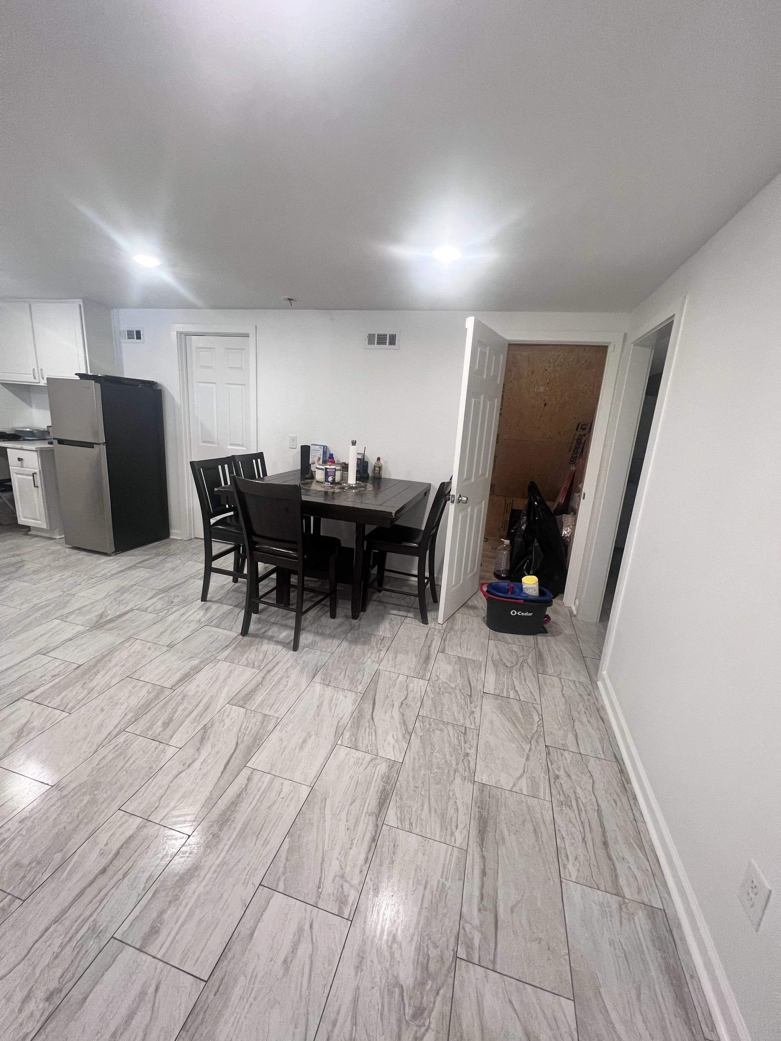 Dining area and kitchen prepared after detailed apartment cleaning service.