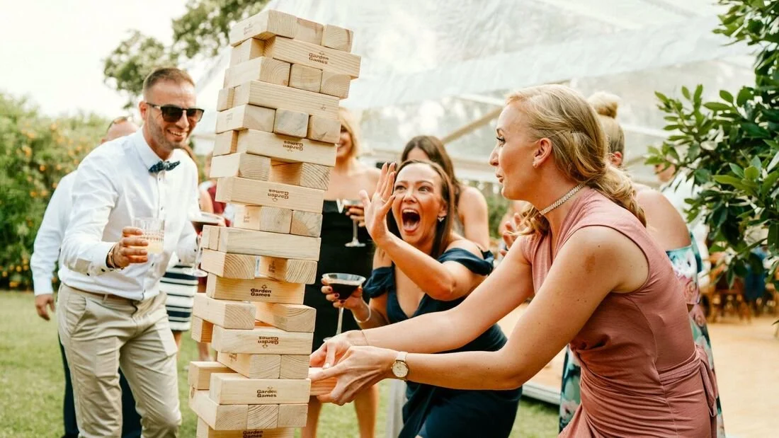 Guests playing giant Jenga from the Giant Yard Games rental at an outdoor Nashville event