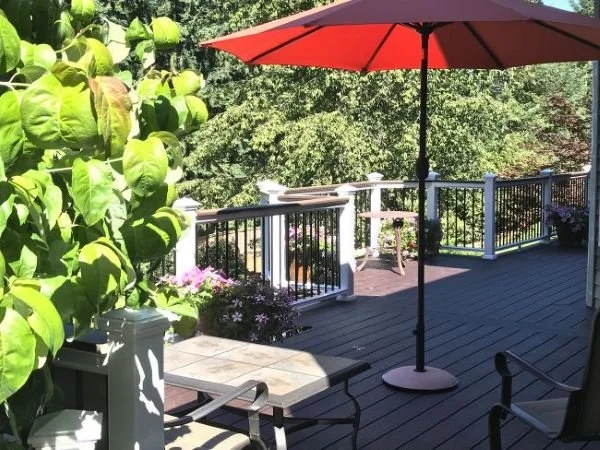 Composite deck with black aluminum railing system installed for safety and unobstructed backyard views in King County, WA.
