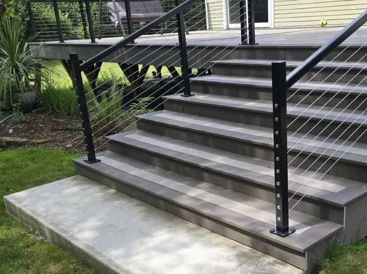 PVC deck replacement in Maple Valley featuring wide deck stairs with black aluminum cable railing and low-maintenance decking