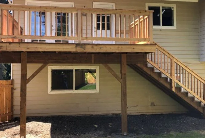Elevated deck construction in Black Diamond WA showing support posts, framing, and stairs designed for slope and structural stability