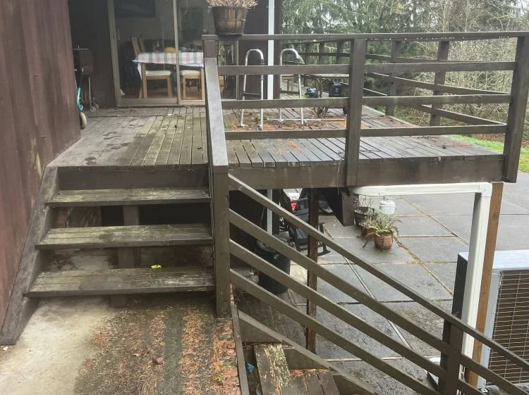 Aging deck with worn boards and unstable stairs before replacement