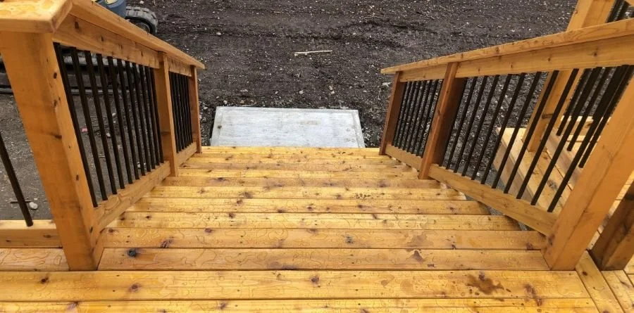 Repaired deck stairs with secure treads and railings restoring safe access