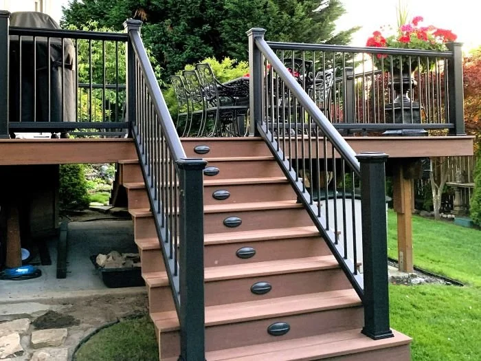 Deck renovation with updated stairs, railings, and integrated step lighting