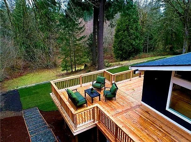 Cedar decking used in a natural backyard setting with wood railings
