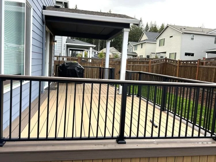 Covered deck with integrated roof structure and perimeter railing