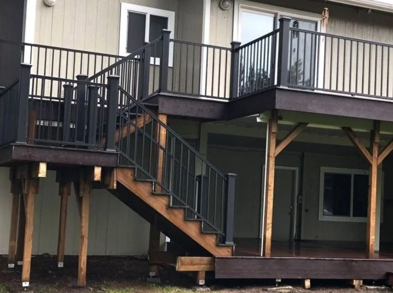 Complete replacement of a custom multi-level elevated deck with composite decking, aluminum railings, and cedar stairs built by Petra Decks in King County.