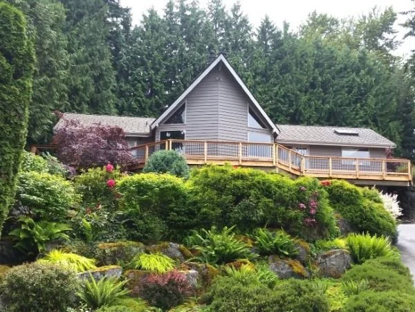 Custom cedar deck built for a hillside home in North Bend, WA with views of the surrounding evergreen landscape.
