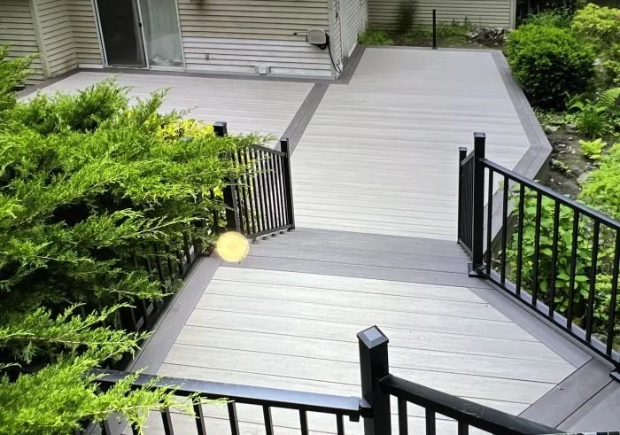 Elevated deck construction in Issaquah WA with stairs and railing designed for slope, drainage, and structural stability