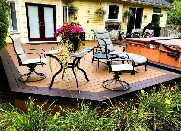 Completed composite deck construction in Issaquah WA with seating area and hot tub designed for durability and outdoor living