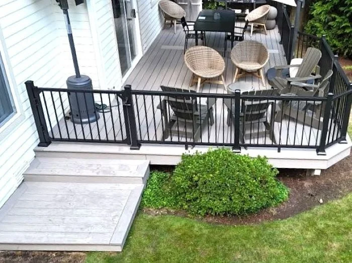 Composite deck remodel in Issaquah, WA with black aluminum railing and outdoor seating area