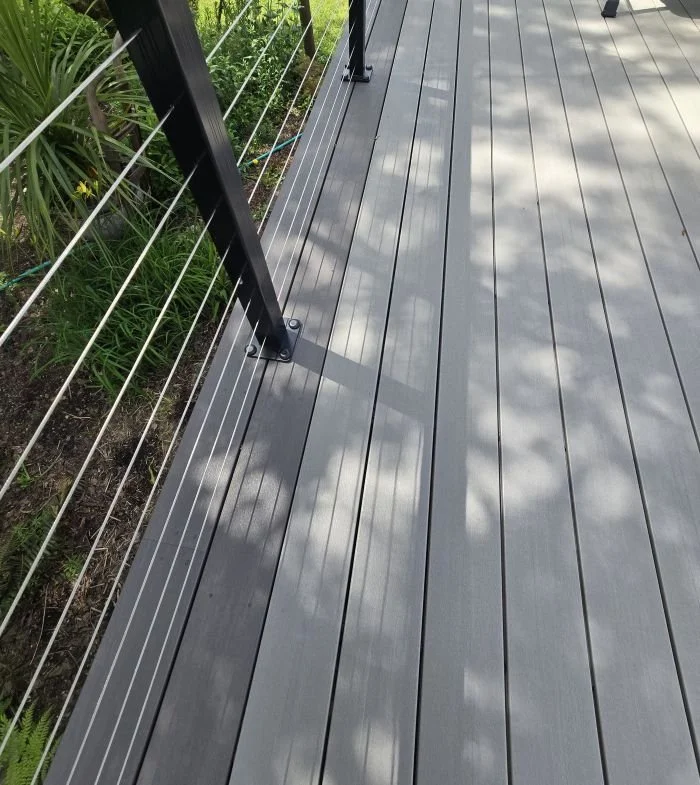 Composite deck replacement project in Redmond, WA featuring upgraded cable railing system, moisture-resistant decking materials, and improved outdoor usability designed for long-term performance.