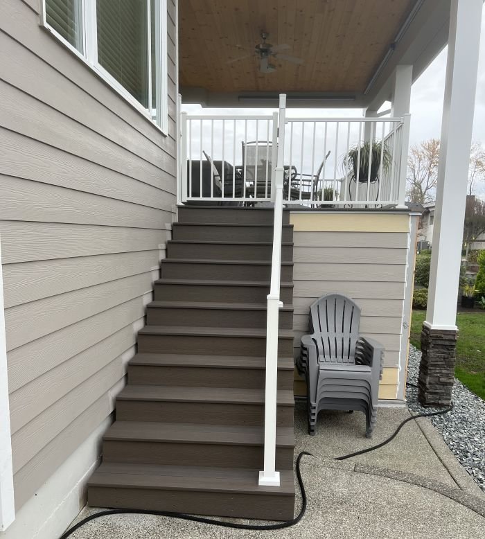 Composite deck with stairs and white railing system at residential home in Auburn, WA