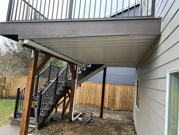 Under-deck waterproofing system installed beneath an elevated deck to create a dry, protected outdoor living space with integrated drainage by Petra Decks in King County, WA.