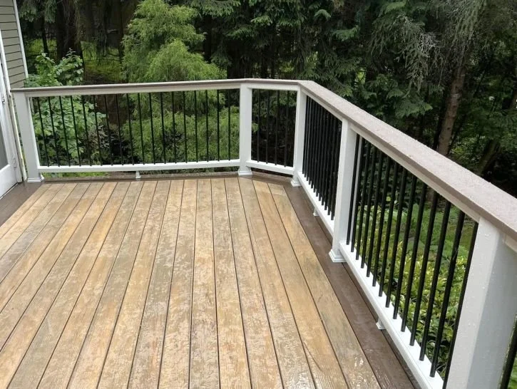 Corner deck railing installation with vertical balusters on an existing deck