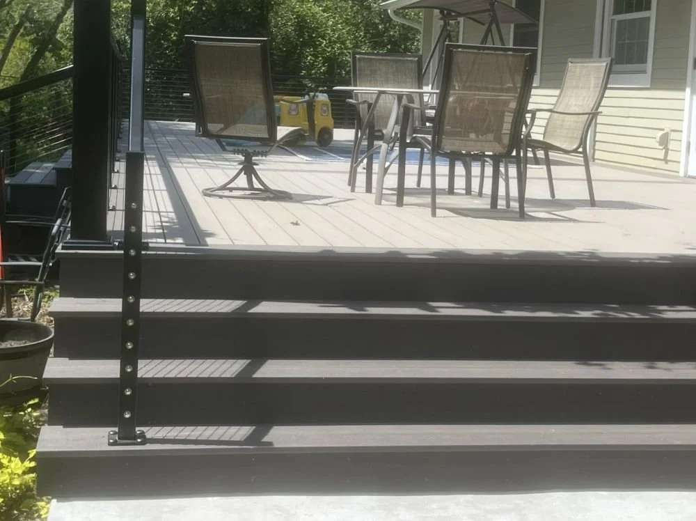 PVC deck replacement project in Renton, WA featuring gray PVC decking, custom stairs, and black metal railings designed for durability, low maintenance, and long-term outdoor performance.