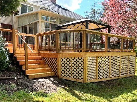 Completed cedar deck renovation with rebuilt stairs and railing in Renton, WA