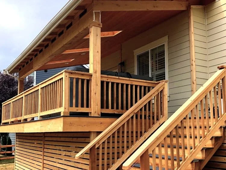 Covered cedar deck with integrated stairs, wood railing, and attached roof structure