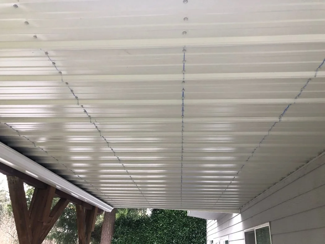 Under-deck waterproofing system with installed drainage panels creating a dry space below