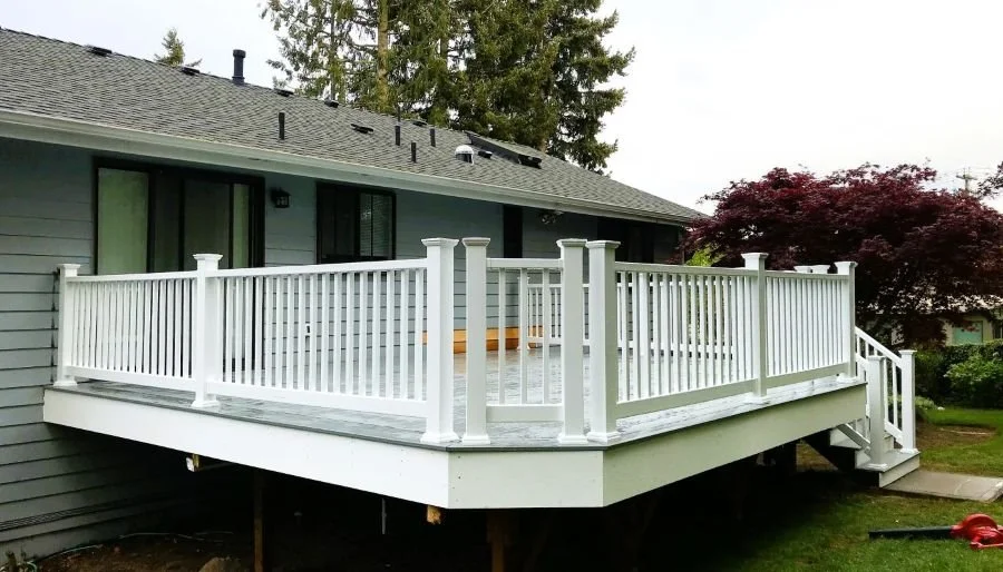 Custom elevated deck with white railing system built by Petra Decks for a homeowner in Covington, WA.